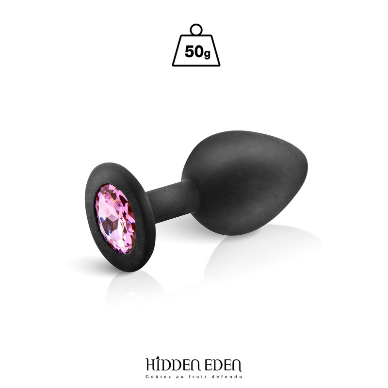 Plug bijou silicone noir M Hidden Eden posé délicatement sur un tissu satiné pour une ambiance élégante